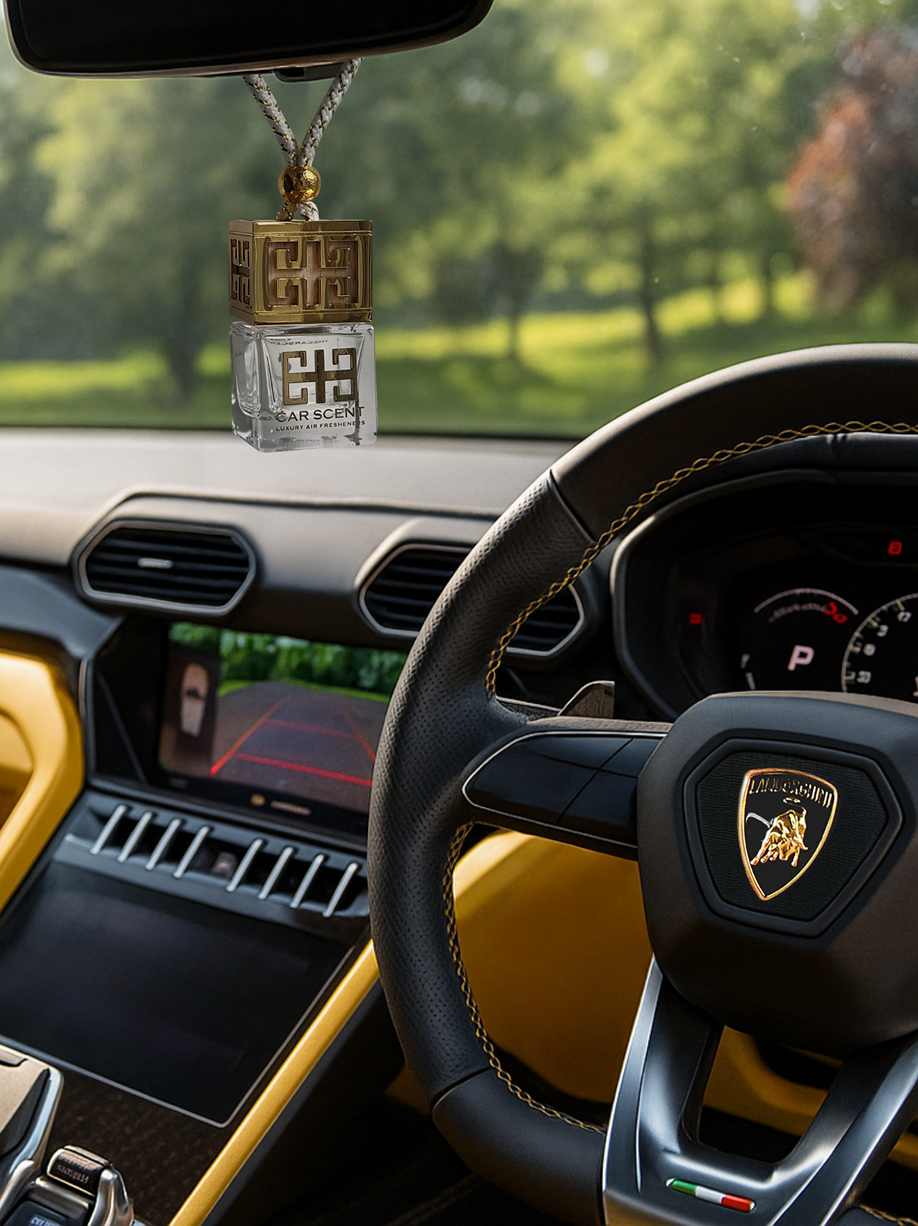 Car interior with a steering wheel featuring a logo, dashboard, and a hanging car air freshener.